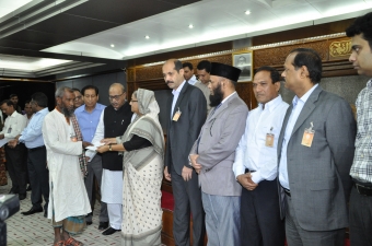 The Prime Minister handed over cheques of Tk 7 lakh to each Tazreen Fashions fire victim